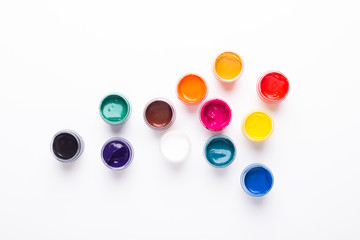 Multicolored gouache on a white background Isolated Paints in containers Top view Copy space