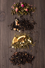 Several views of tea on a wooden background