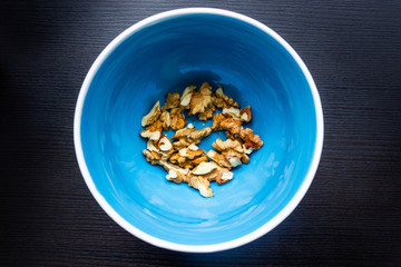 Close up of healthy brown walnuts scattered on the wooden table