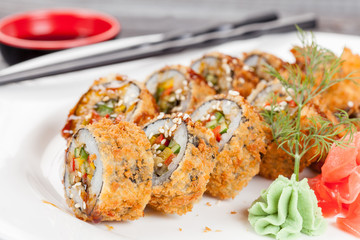 Japanese national popular cuisine. Sushi, rice and fish. Tasty, beautifully served food in a restaurant, cafe, with elements of the original design.
