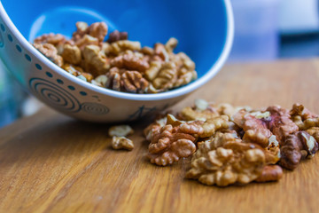 Close up of healthy brown walnuts scattered on the wooden table