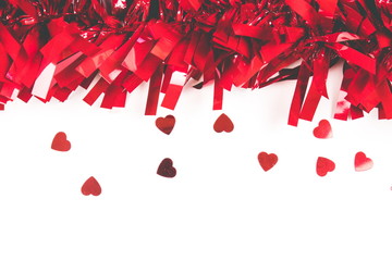 Red confetti in the form of the heart on the white background. The place for your text and design.