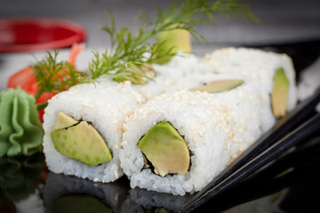 Japanese national popular cuisine. Sushi, rice and fish. Tasty, beautifully served food in a restaurant, cafe, with elements of the original design.