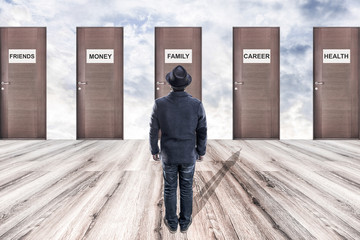 a man in a hat stands in front of wooden doors, the concept of choice life values