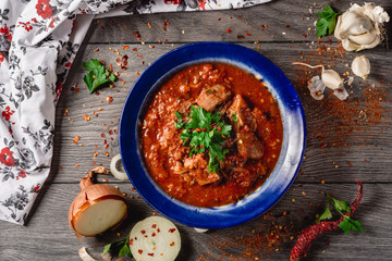 Stewed veal meat with spices in a tomato sauce, veal meat in tomato sauce with onion, garlic, chili...