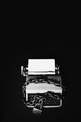 Obraz na płótnie Canvas Information censorship - Typewriter locked with a chain