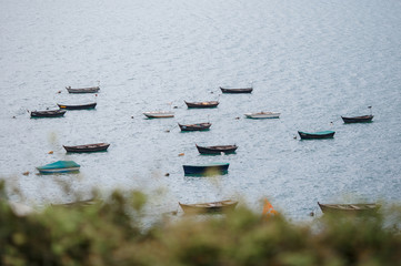many retro boats near the shores of a lake