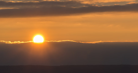 The sun is just above the clouds