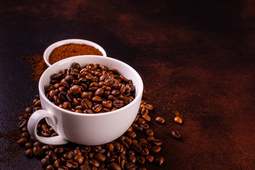 Seeds of fragrant coffee, coffee drink on a dark concrete background. It can be used as a background