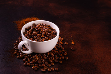 Seeds of fragrant coffee, coffee drink on a dark concrete background. It can be used as a background