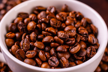 Seeds of fragrant coffee, coffee drink on a dark concrete background. It can be used as a background