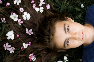 Faceless girl lying in grass