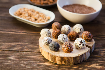 the vegan of handmade candy and ingredients on a wooden background. Fitness sweets. candies without sugar. vegan snack.