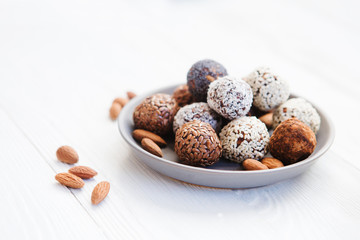 the vegan of handmade candy and ingredients on a wooden background. Fitness sweets. candies without sugar. vegan snack.