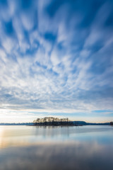 An island with trees during a winter sunset with beautiful clouds in the sky