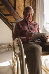 Senior man using laptop in living room