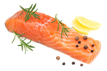 Red fish. Raw salmon fillet with rosemary and lemon isolate on white background.