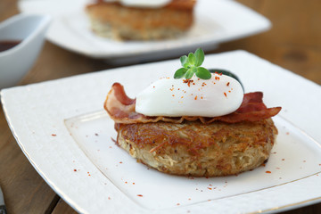 Potato rosti, poached egg and bacon on top.