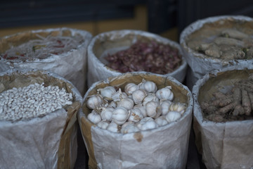 Paper-wrapped buckets with agricultural products in the warehouse of the provincial market. Vietnam