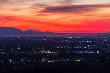 Colorful predawn view of San Fernando Valley neighborhoods and the San Gabriel Mountains in the city of Los Angeles, California.  