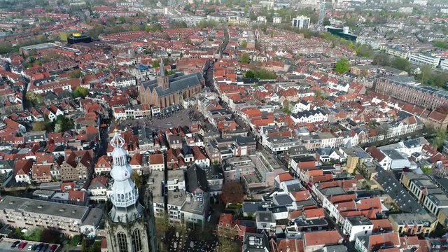 Aerial view of downtown Amersfoort city located in the province of Utrecht Netherlands showing Hof Square and Sint Joriskerk then moving backwards past onze lieve vrouwetoren bell tower 4k quality
