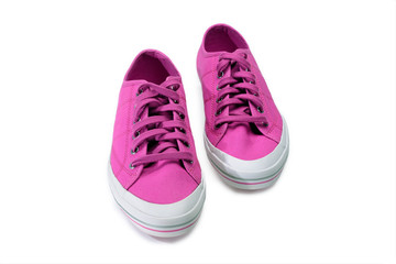 Pair of pink gumshoes. Fuchsia sneakers isolated on a white