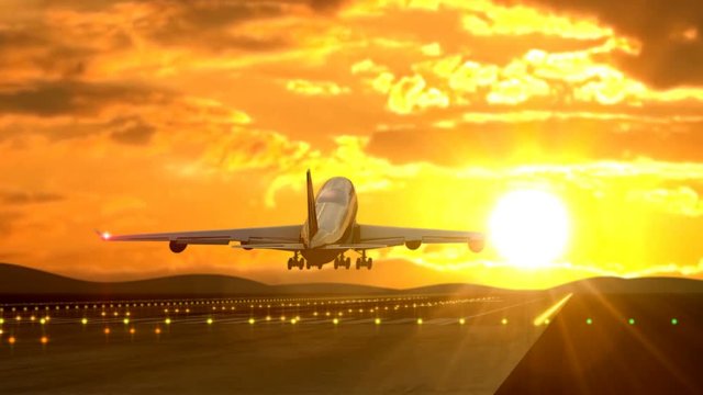 Large passenger airplane landing against golden sunset captured by handheld camera