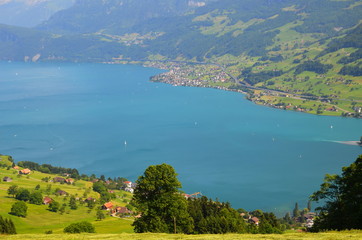 View of mountain lake with sailing boats in Switzerland