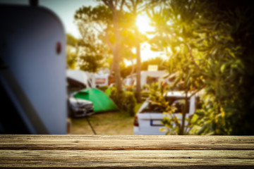 A campsite in a sunny place with a wooden board for an advertising product   