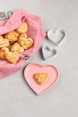 Homemade Heart-Shaped Biscuits in a Bread Basket Lined with a Pink Napkin