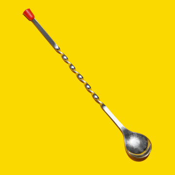 Cocktail bar spoon on a yellow background