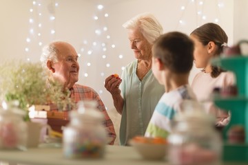 Multi-generation family celebrating birthday at home