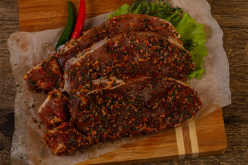 Raw marinated pork steak