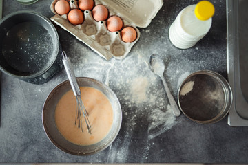 Up down shot of pancakes in the kitchen, home with flowers, eggs, fruits on the table.