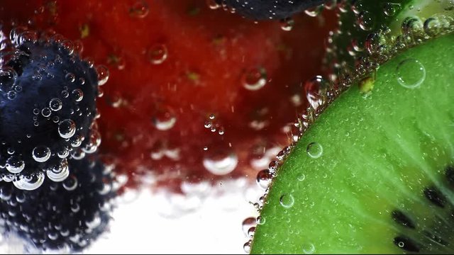 fresh fruits in the water with drops of water