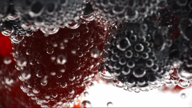 Fresh fruits in the water with drops of water