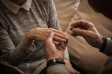 Senior couple with an engagement ring.