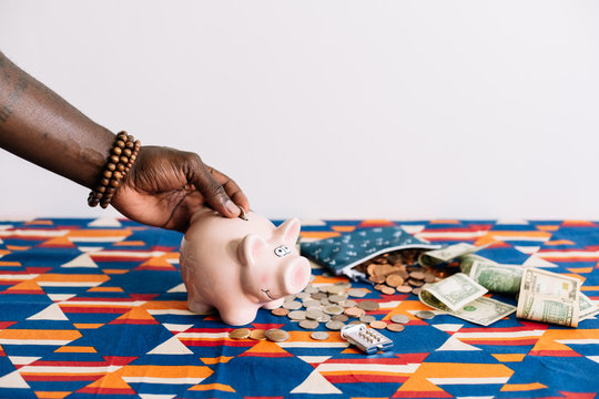 Man adding money to Piggy bank