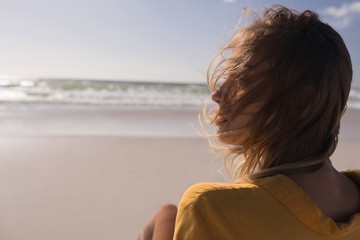 Young woman relaxing at beach on a sunny day