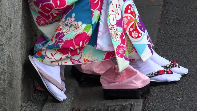 Feet of girls in traditional Japanese garment & footwear.
