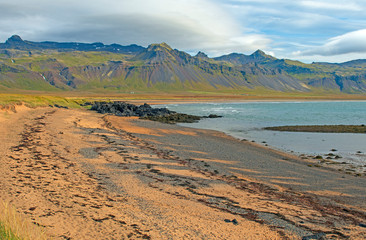 Golden Sand Beach with Lava and Mountains