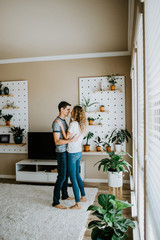 Happy Couple Dancing in Modern Living Room