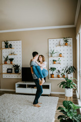 Happy Couple Dancing in Modern Living Room