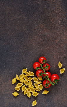  Pasta and tomatoes on a concrete background. Italian food background. Ingredient for cooking.