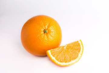 Juicy fresh orange and one orange slice. Fruits are isolated on a white background. Close photo. 