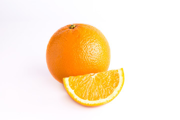 Juicy fresh orange and one orange slice. Fruits are isolated on a white background. Close photo. 