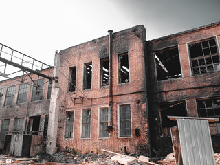 Burnt house facade after fire, abandoned ruined building in coal