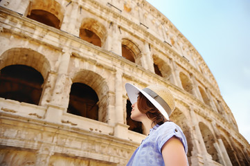 Fototapeta na wymiar Young female traveler looking on famous the Colosseum in Rome.