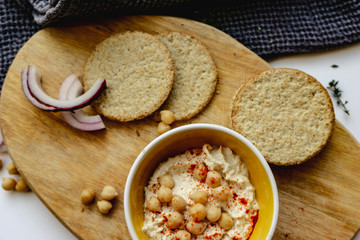 Oatcakes and hummus photographed from above.