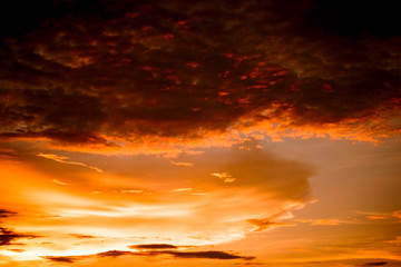 Fototapeta na wymiar Dramatic sunset colorful red and orange sky over and cloud background multicolor evening sky